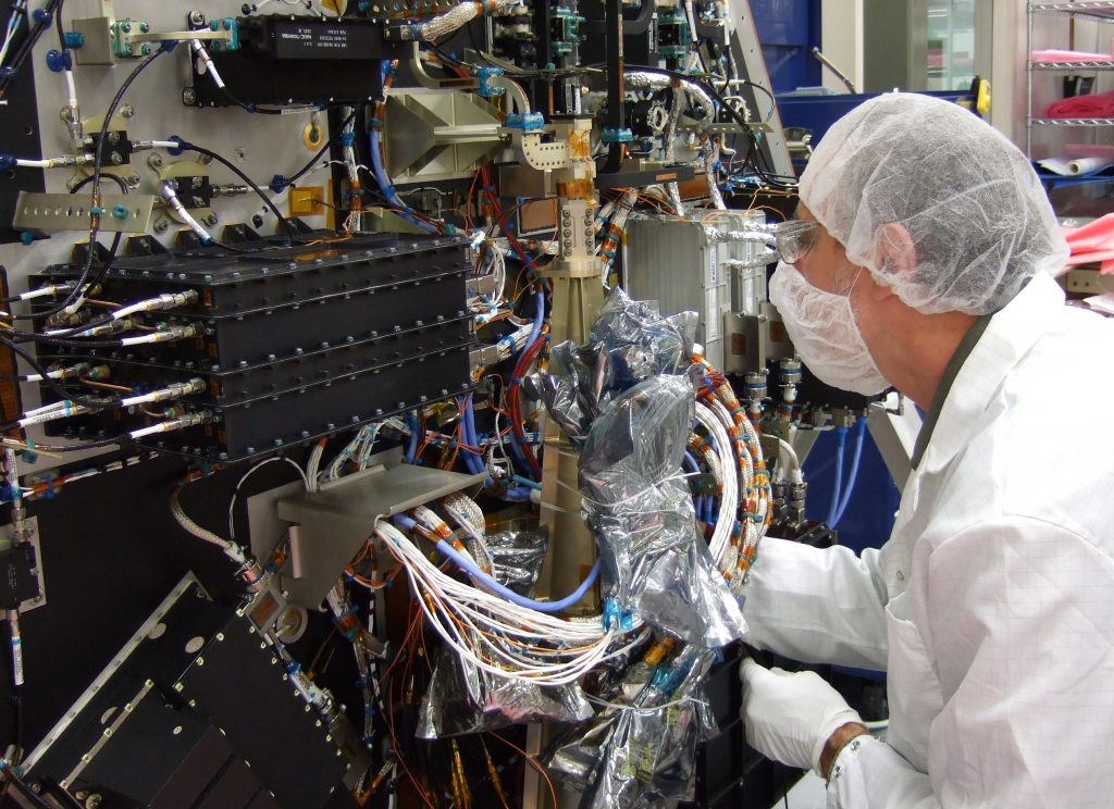 Space engineer working on a satellite bus.